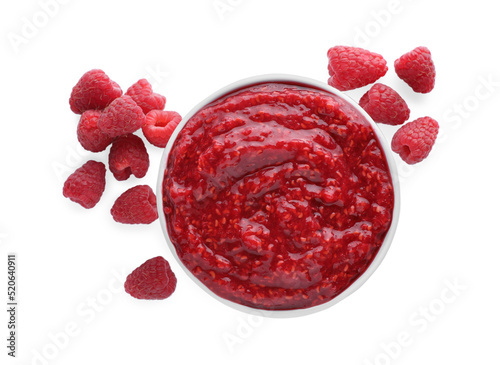 Raspberry puree in bowl and fresh berries on white background, top view