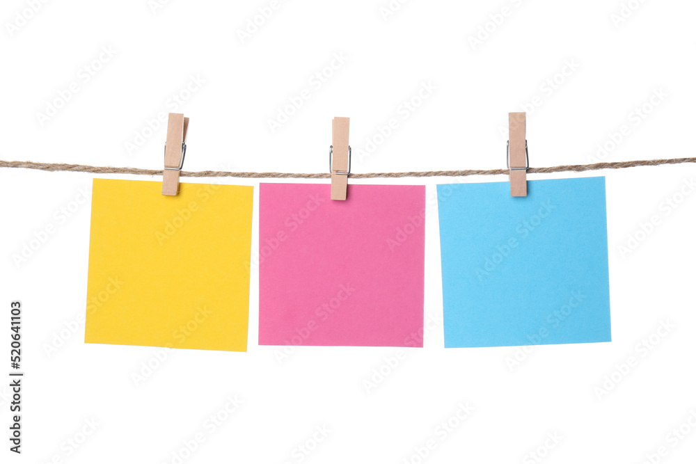 Clothespins with empty notepapers on string against white background. Space for text