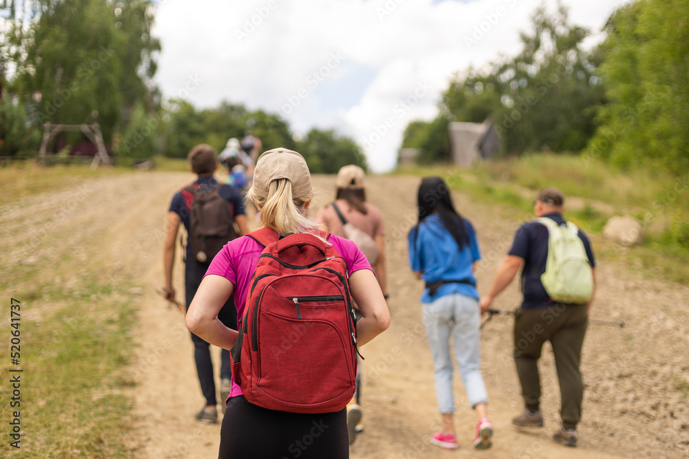 Group of hikers with backpacks climbing up mountains Group of hikers with backpacks climbing up mountains