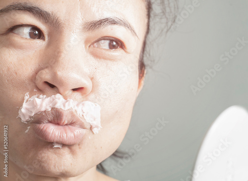 Φωτογραφία image of woman removing excess hair on my own face by using a cream that is a ha