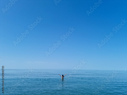 Precious image of a woman in the vastness of the ocean