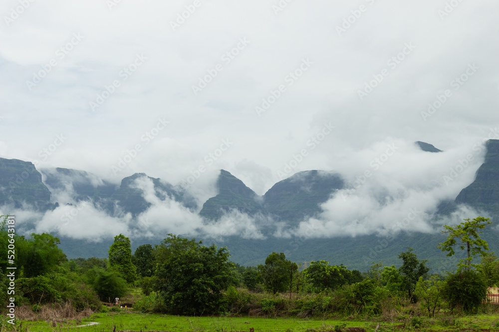 The Beautiful View of Sahyadri Mountain Range, Clouds Touching Hills and Hut Near The Hill, 