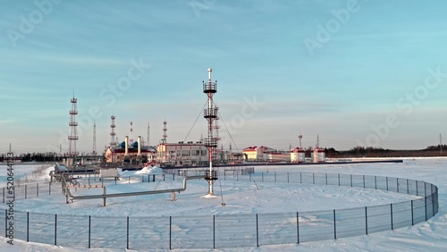 A drone flies around a pipe to relieve emergency gas pressure on the pipeline of an oil and gas refinery in Russia in winter. Fuel crisis, rising prices for gas and gasoline in Europe and the USA.