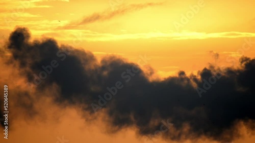 Dramatic black smoke with orange dawn sky