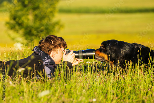 boy and hovie, two friends, a dog sticks its snout in the lens hood