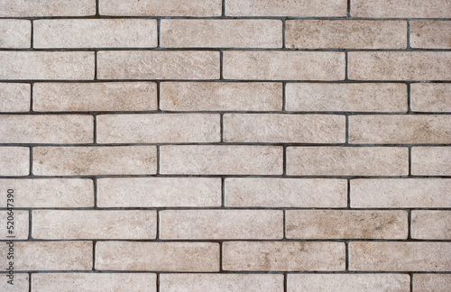 Background of a wall of gray and dirty bricks close-up
