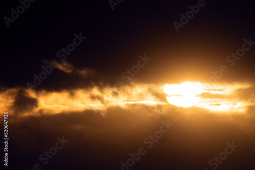 Light in the dark. Sun and storm clouds. Abstract natural background.
