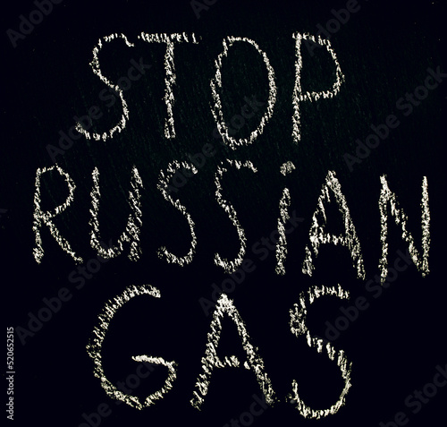 White chalk inscription of words on black board stop Russian gas. Embargo on the sale of energy products from Russia. Call not to buy Russian gas. Crisis and lack of energy resources