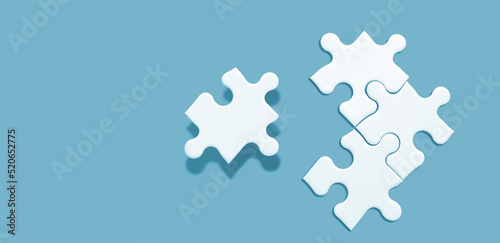 White jigsaw puzzle on green background, Find the right joined team and fit correctly concept, space for writing copy