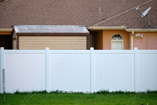 White plastic fence for back yard protection and privacy