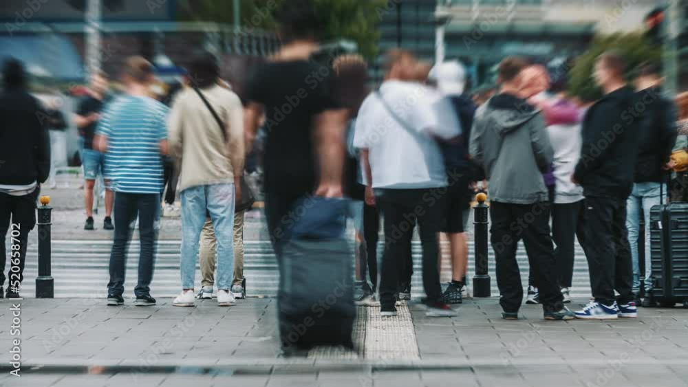 Time-lapse unrecognizable people crowd crossing city street, busy crossroad, pedestrians crossing crosswalk intersection, car traffic. Timelapse rush hour crowded people walk, daylight, fast motion