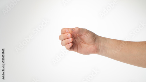 Hand male gesture fingers clenched into a ring holding a cylinder