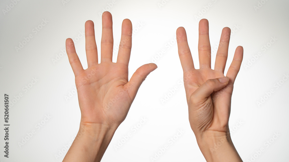 Women's hands gesture counting on fingers nine palm side