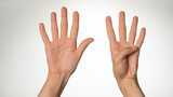 Women's hands gesture counting on fingers nine palm side