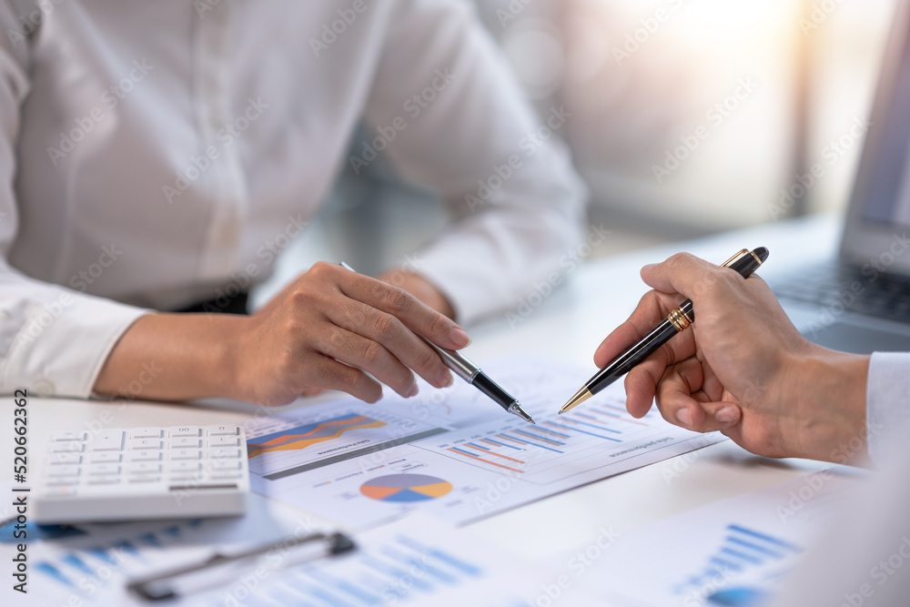 Fototapeta premium Close-up view of businessman analyzing graphs and organization chart explain to the meeting the future business trends in the organization.