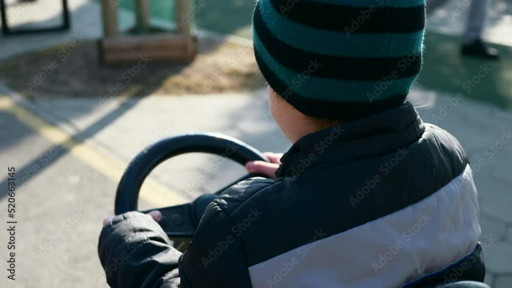 Kid Rides Pedal Go Cart Toy Car. Happy Child Boy Rest in City Park Spring Sunny Day. 2x Slow motion 60fps 4K