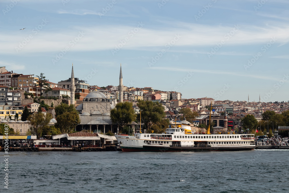 View of traditional ferry boat at Uskudar pier on Asian side of Istanbul. It is a sunny summer day. Beautiful scene.