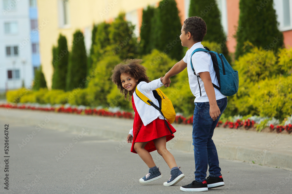 Fototapeta premium The children are going back to school. The girl is impatiently rushing to school