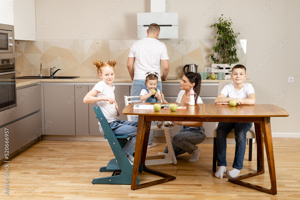 learning at home, children in the kitchen studying while the whole family is sitting at the table with them learning at home, children in the kitchen studying while the whole family is sitting at the table with them