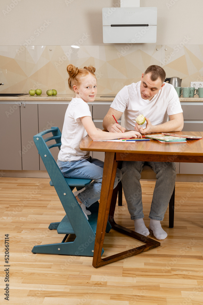 distance learning, daughter learns lessons in the kitchen the whole family helps her distance learning, daughter learns lessons in the kitchen the whole family helps her
