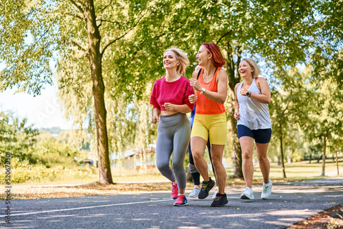 Group of women jogging together in park