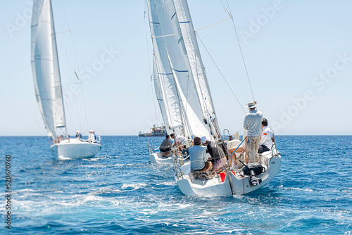 Sailing crew on sailboat during regatta