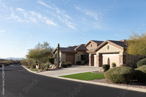 Beautiful new luxury real estate with front yard and driveway photo