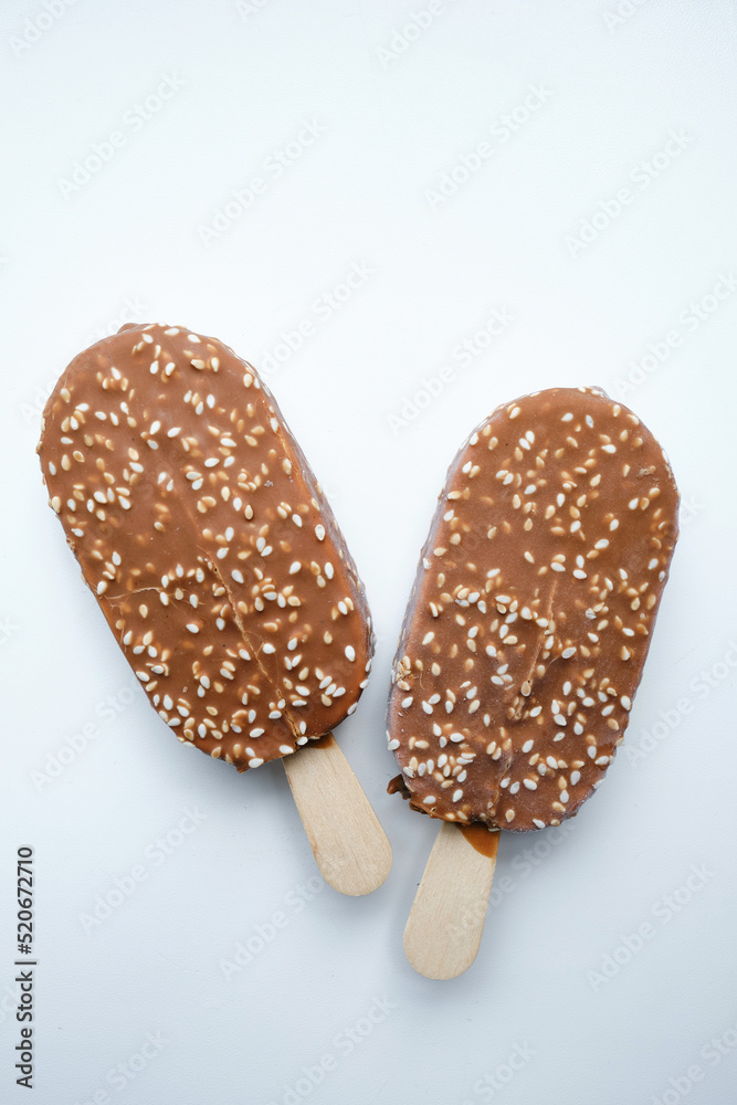 Ice cream in chocolate glaze on a light background. Natural ice cream close-up. Summer sweet delicious cold dessert. traditional dairy product
Ice cream in chocolate glaze on a light background. Natural ice cream close-up. Summer sweet delicious cold dessert. traditional dairy product