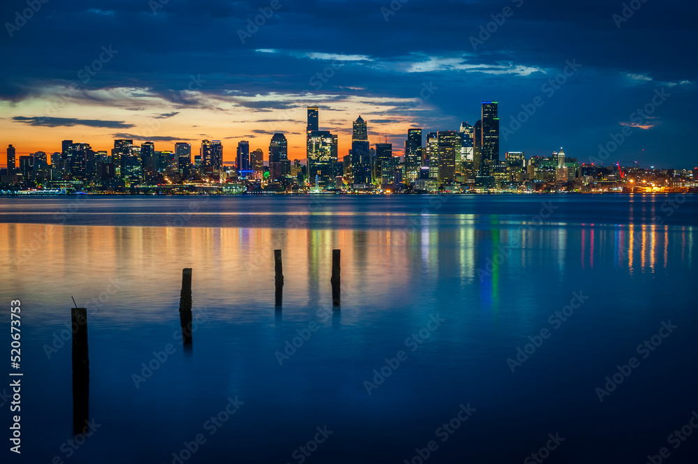 Seattle Skyline During the Morning Blue Hour Seen From West Seattle.  Dynamic view of the Seattle cityscape just before dawn with Elliott Bay in the foreground and the waterfront in the distance. 