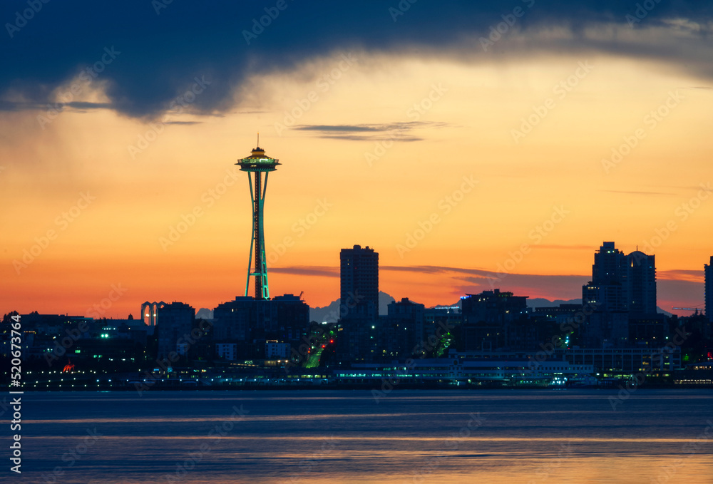 Space Needle Silhouetted Against a Red Sky Just Before Sunrise. The historic World's Fair landmark says Seattle, Washington as seen from west Seattle along Harbor Boulevard on a summer morning.
