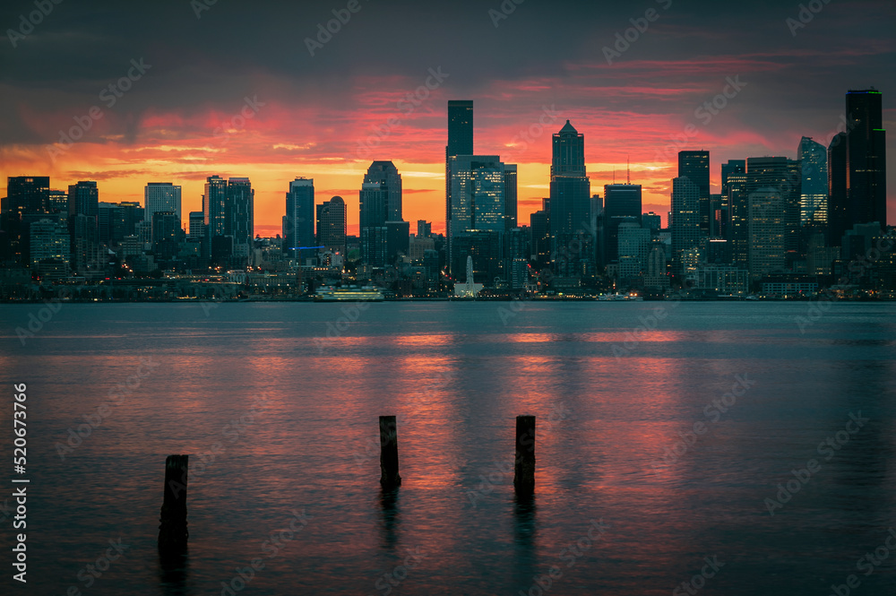 Seattle Skyline During the Morning Blue Hour Seen From West Seattle.  Dynamic view of the Seattle cityscape just before dawn with Elliott Bay in the foreground and the waterfront in the distance. 