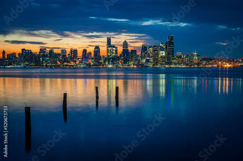 Seattle Skyline During the Morning Blue Hour Seen From West Seattle. Dynamic view of the Seattle cityscape just before dawn with Elliott Bay in the foreground and the waterfront in the distance. 