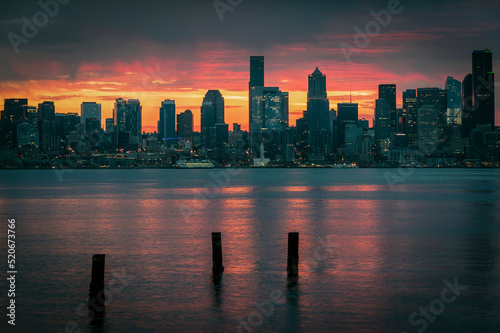 Seattle Skyline During the Morning Blue Hour Seen From West Seattle.  Dynamic view of the Seattle cityscape just before dawn with Elliott Bay in the foreground and the waterfront in the distance. 