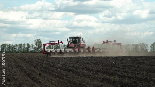 tractor works in the field. sowing corn. precision farming. photo