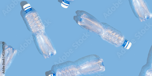 Plastic bottles on a blue background pattern. Waste recycling concept.