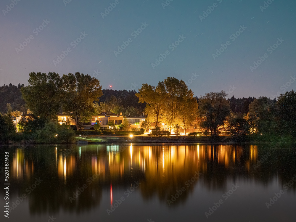 Evening picture of houses next to small lake in Koseze (Lubiana, Slovenia)