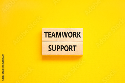 Teamwork support symbol. Concept words Teamwork support on wooden blocks on a beautiful yellow table yellow background. Business and teamwork support concept. Copy space.