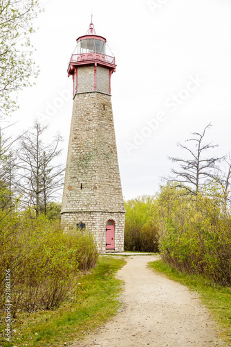 Tall stone lighthouse on an island