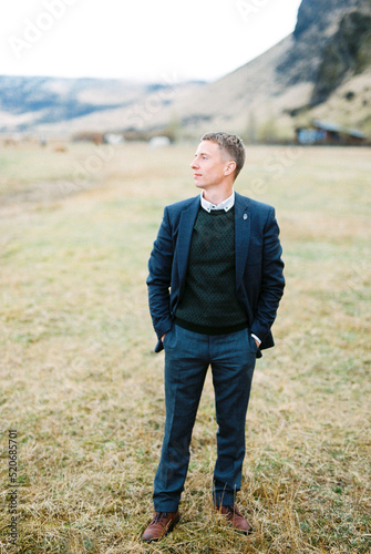 Man in a suit stands in a mountain valley. Iceland © Nadtochiy