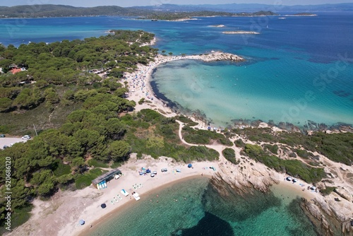 Karidi, Greece. Small, yet very beautiful natural beach located on the Halkidiki Peninsula. Some tourist relaxing and sunbathing. Aerial view. High quality photo