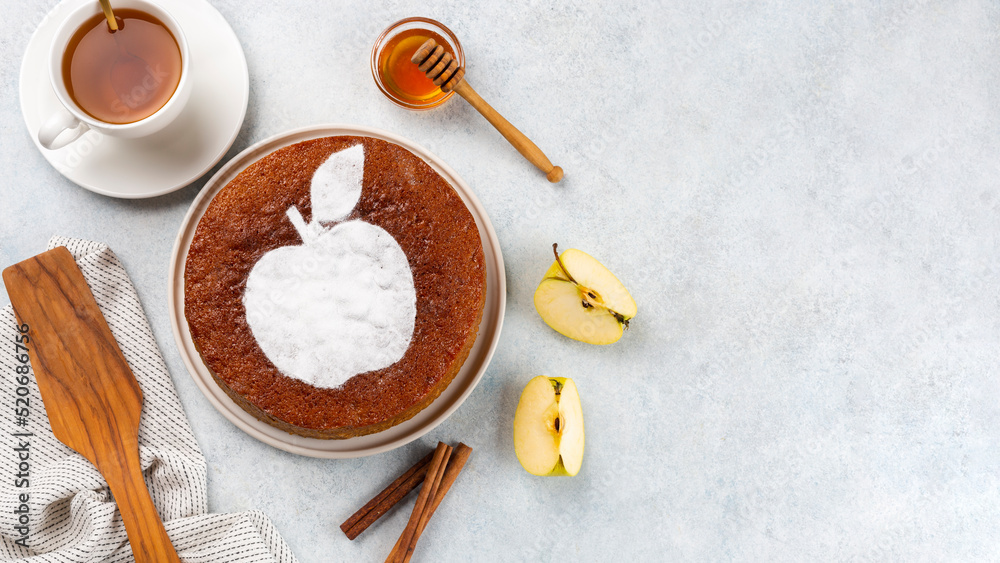 Fototapeta premium Homemade apple pie on a white wooden background, top view. The classic autumn dessert for Thanksgiving is organic apple pie.