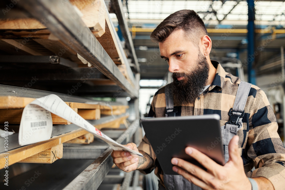 An industry worker checking on bus construction in vehicle production factory. An industry worker checking on bus construction in vehicle production factory.