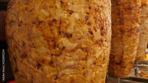 Traditional spinning spit of doner kebab meat in Turkish street snack bar