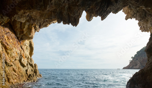 Picturesque waterfront caves at Mediterranean coast in summer