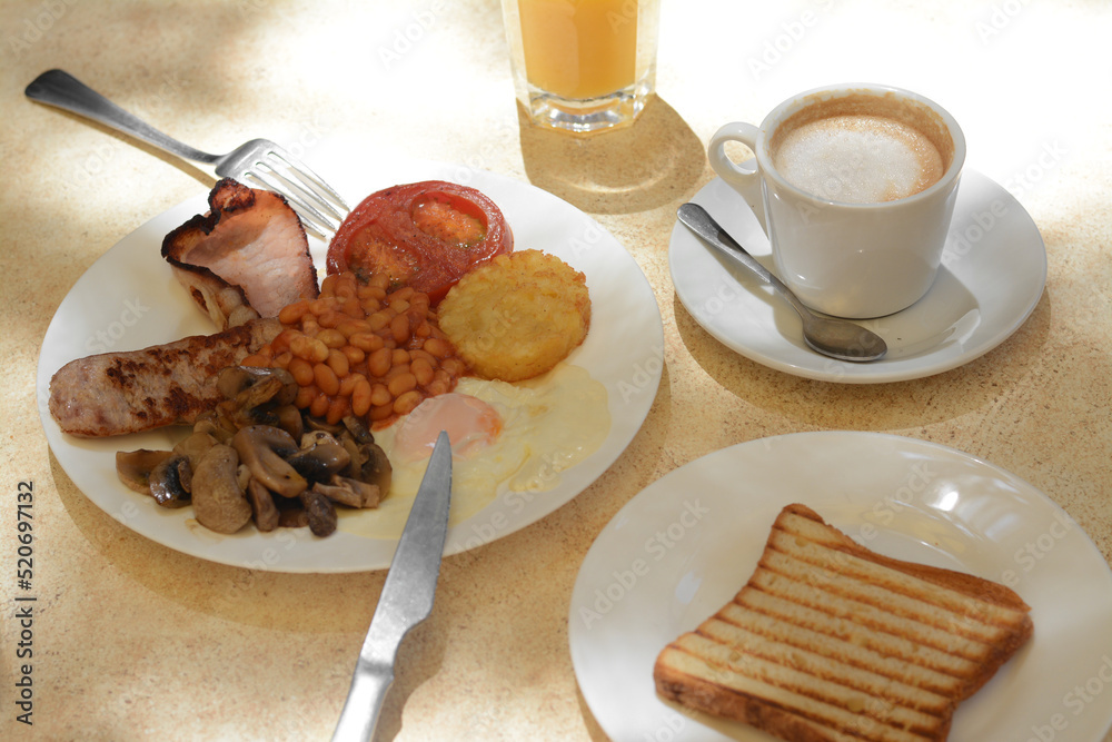 Delicious breakfast with fried meat and vegetables served on beige table Delicious breakfast with fried meat and vegetables served on beige table