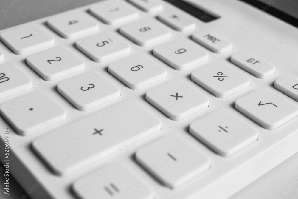 Closeup view of white calculator on light background Closeup view of white calculator on light background