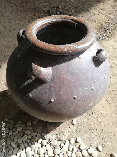 Ceramic pottery in brown color placed on the floor during a sunny day