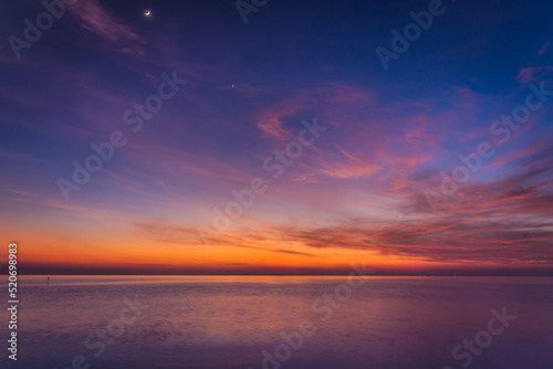 Obraz na płótnie sunset sky with dramatic sunset clouds over the sea