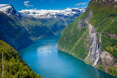 Fototapeta Naklejka Na Ścianę i Meble -  Ferry ship crossing Geirangerfjord and Seven Sisters Waterfalls, Norway