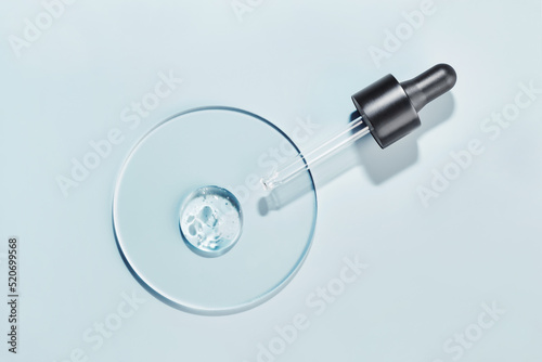 Cuadro en lienzo Pipette with sample of gels cosmetic product in petri dish on blue background, h